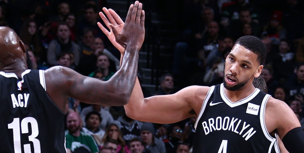 Jahlil Okafor sous le maillot des Nets, frappant dans la main de Quincy Acy.