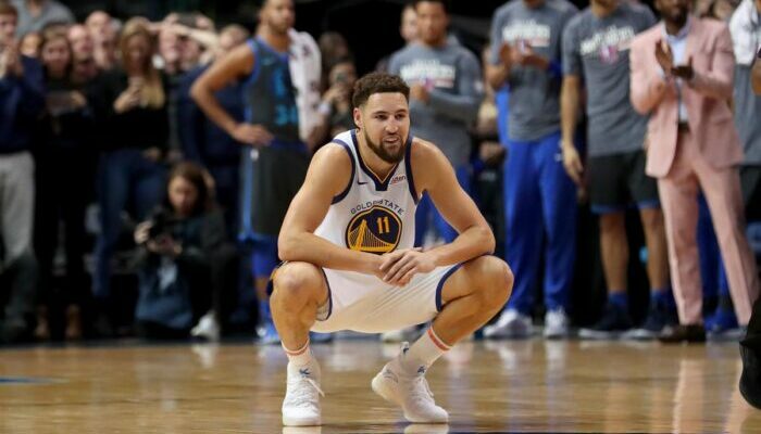 klay Thompson accroupi sur le parquet