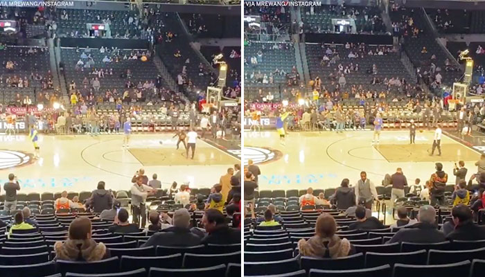 Stephen Curry s’échauffant au tir à trois points depuis le logo du Barclays Center, à Brooklyn, New York.