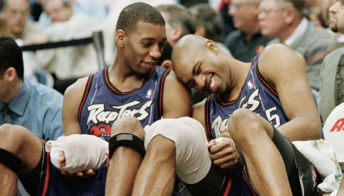 Les légendes NBA Tracy McGrady et Vince Carter en plein fou rire sur le banc des Toronto Raptors