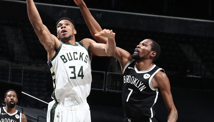 Les deux superstars NBA Giannis Antetokounmpo et Kevin Durant, à la lutte sous le panneau lors d’un match entre les Milwaukee Bucks et les Brooklyn Nets